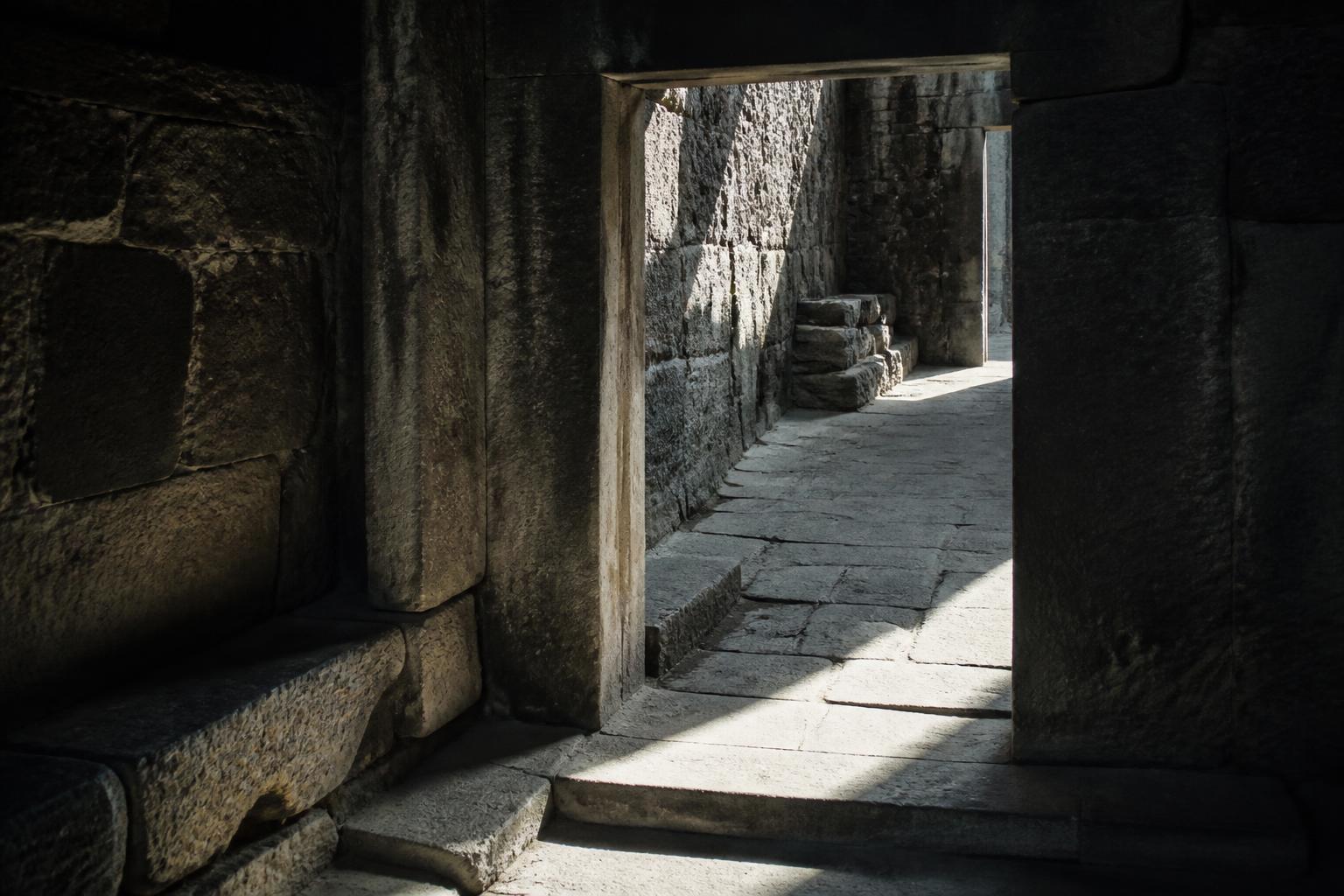 A shaft of light crossing an ancient stone threshold